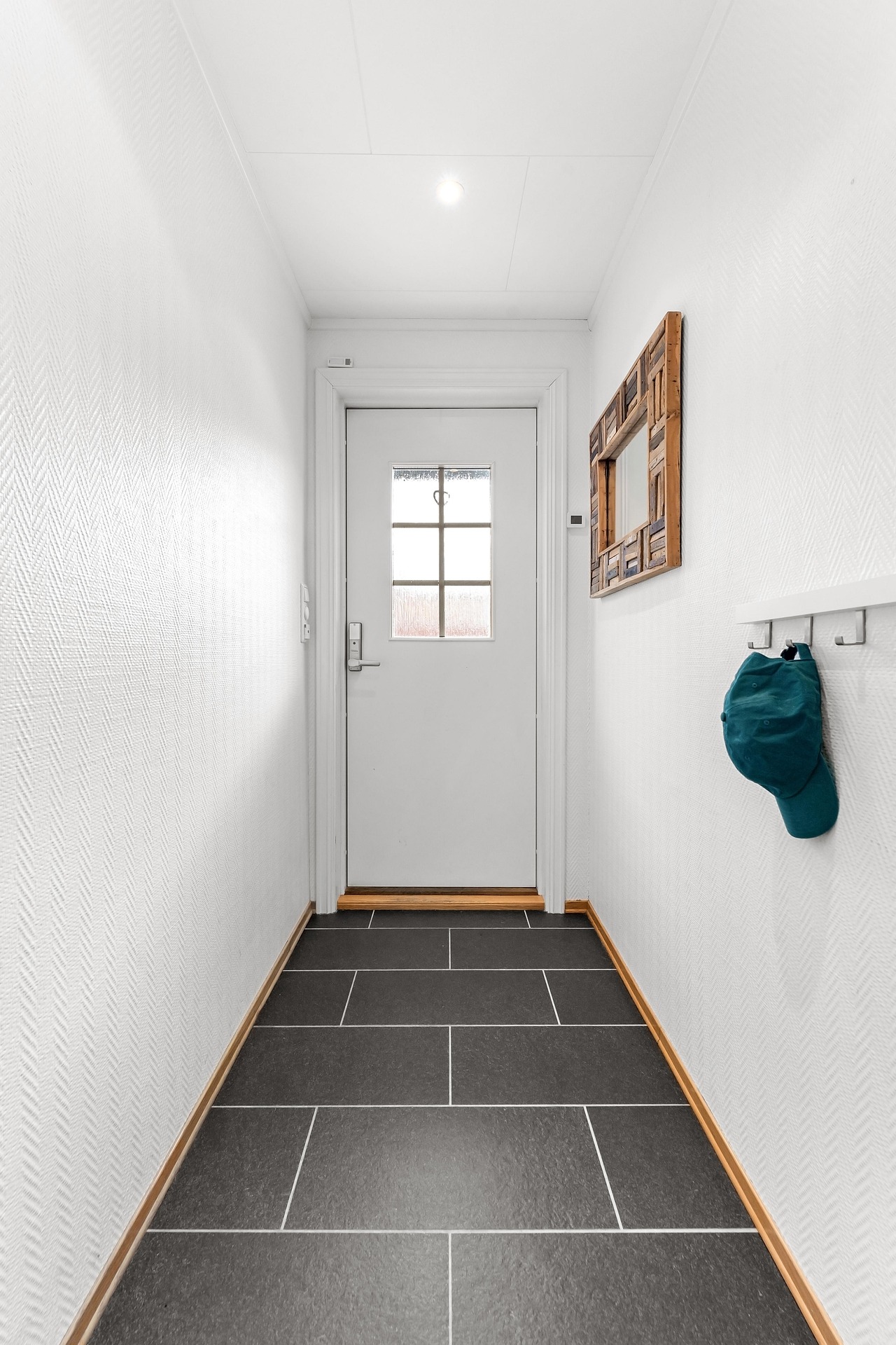 Laminate-style flooring in a bright hallway.