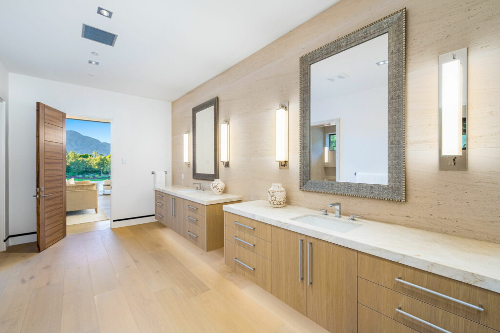 Laminate flooring in a large bathroom with doubly vanity by FloorCo Premium in Temple, Waco, and Killeen, Texas.